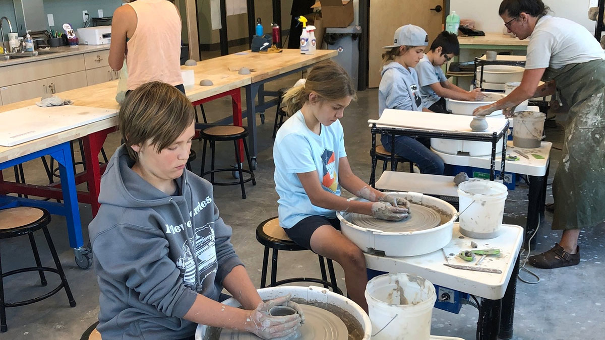 Afterschool ARTventure Class with kids on pottery wheels.